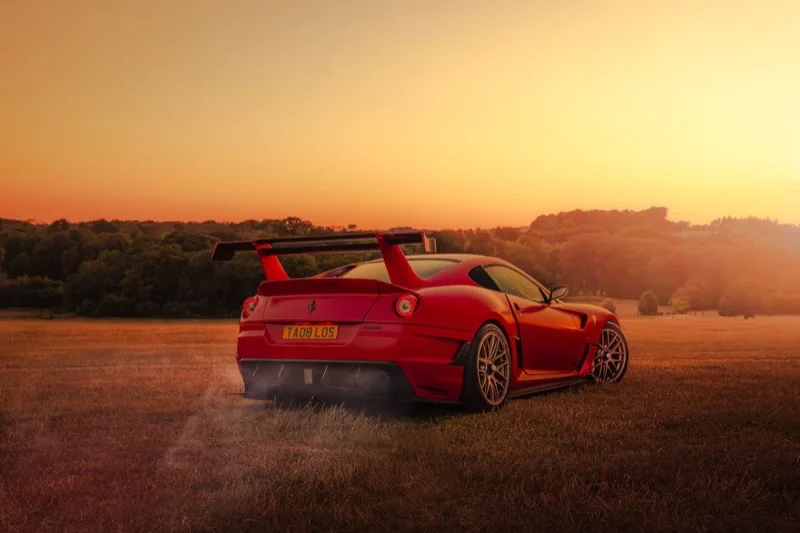 Ferrari 599XX GTO in Rosso Corsa at golden hour in open Yorkshire field — prestige supercar photography UK
