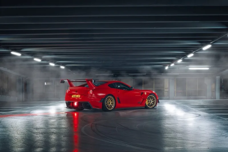Ferrari 599XX GTO rear three-quarter — atmospheric smoky carpark, prestige automotive photography UK by 013Create